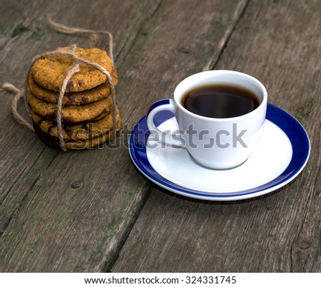 still life a cup of coffee and a linking of oatmeal cookies on an old table, a subject food and drinks