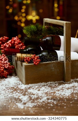 Beautifully decorated box with bottles of wine on unfocused background