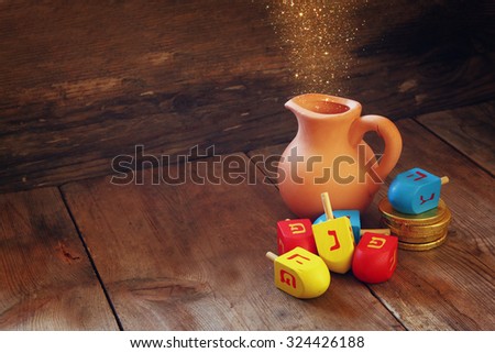 image of jewish holiday Hanukkah and wooden dreidels (spinning top). retro filtered image 
