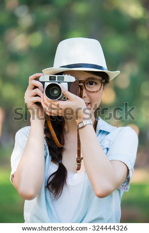 Beautiful young girl smile with retro camera, outdoor travel