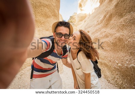 young couple laughs while doing a selfie into the grand canyon - caucasian people - people, lifestyle and nature concept