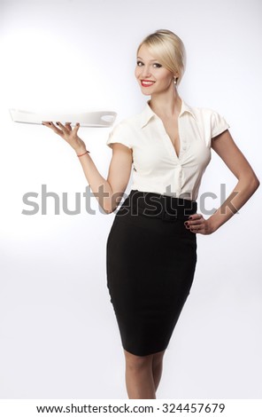 Girl waitress with a tray on a gray background Royalty-Free Stock Photo #324457679