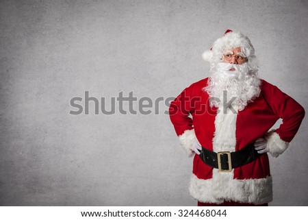 Santa Claus standing surprised in front of a wall