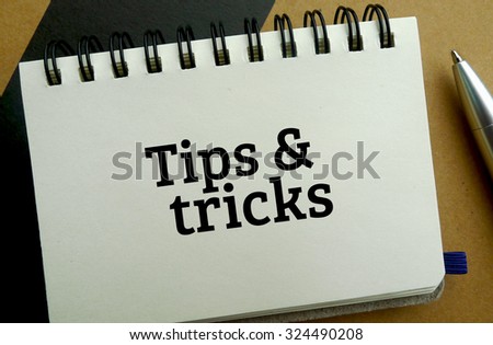 Tips and tricks memo written on a notebook with pen