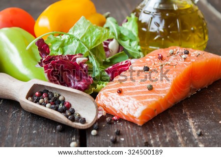 fresh salmon with vegetables on a wooden table Royalty-Free Stock Photo #324500189
