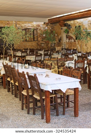 Mediterranean restaurant terrace exterior with chairs.