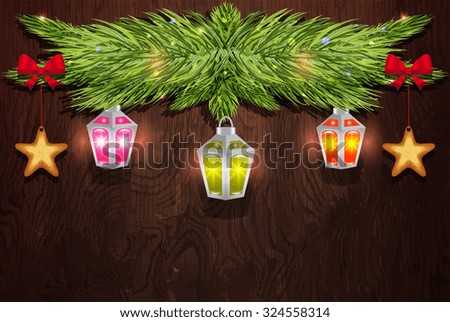Pine branch with Christmas decorations on a wooden background