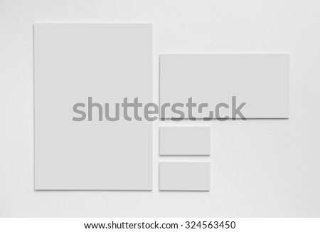 Gray simple stationery mock-up template on white background. Envelope, business cards and A4 paper. Royalty-Free Stock Photo #324563450