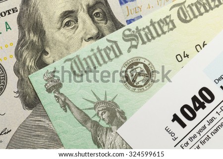1040 Tax Form with Refund Check and Cash. Royalty-Free Stock Photo #324599615