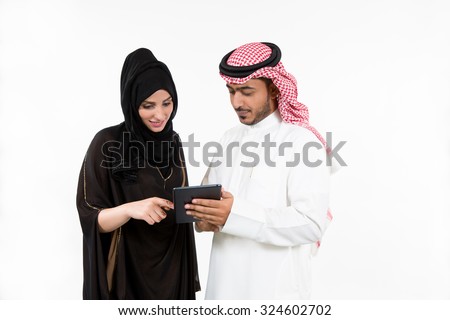 Arab couple using digital tablet