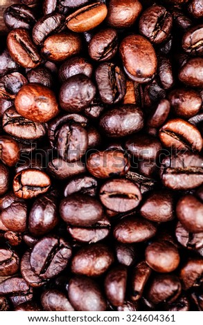 Coffee beans on a grunge wooden background close up 