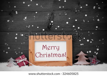 Gray Christmas Card With Brown Picture Frame On White Snow With Snowflakes. Red English Text Merry Christmas, Tree, Christmas Gift And Star. Rustic Wooden, Retro Vintage Background. Black And White