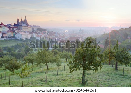 Early morning view of Prague with golden sunrise ~ A panorama over Prague Old Town with majestic Prague Castle and St. Vitus Cathedral on the left and a golden rising sun in the background