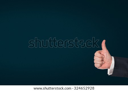 Business man holding the thumbs up, with an dark blue background
