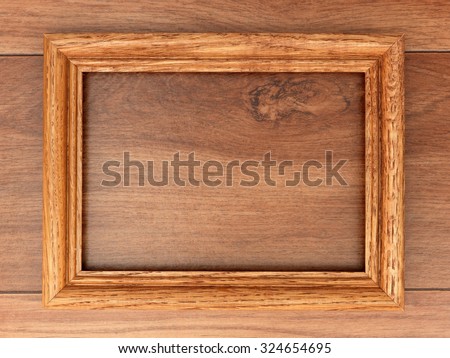 A photo frame on a wooden shelf