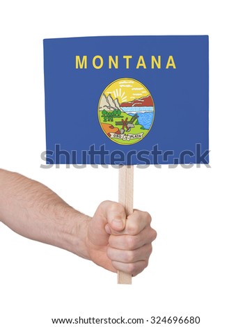 Hand holding small card, isolated on white - Flag of Montana