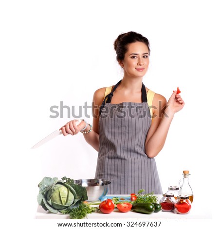 Young Woman Cooking in the kitchen. Healthy Food - Vegetable Salad. Diet. Dieting Concept. Healthy Lifestyle. Cooking At Home. Prepare Food 