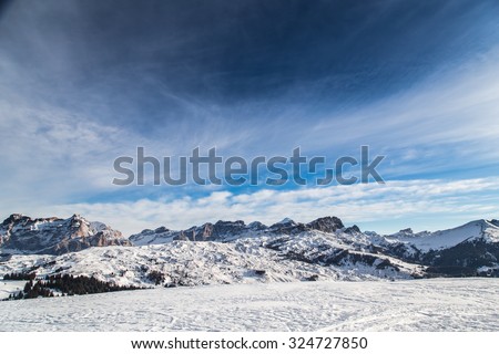 winter in the italian alps, with the ski slope full of snow