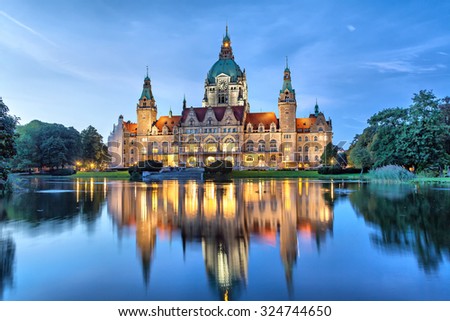 New City Hall of Hannover reflecting in water in the evening, Lower Saxony, Germany Royalty-Free Stock Photo #324744650