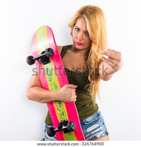 Skateboarder girl making horn gesture