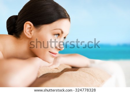 picture of woman lying on the massage desk over sea background