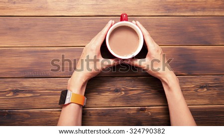 woman holding hot cup of coffee,
