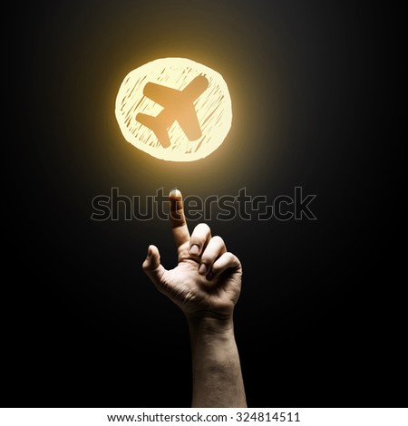 Person hand pointing with finger at glowing icon
