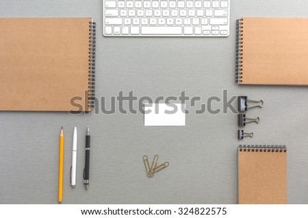 Grey Wooden Desk with Business Items in Calm Classic Colors Mock Up Template of Stationary and Tools in Office Every Day Life Top View Directly from Above with Blank Business Card in Center