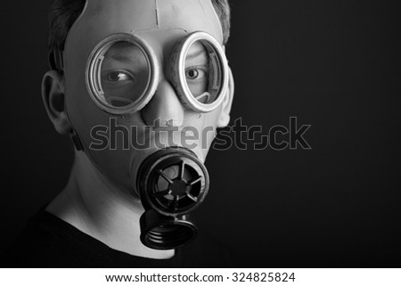 Man with gas mask on black  background.Black and white photo.