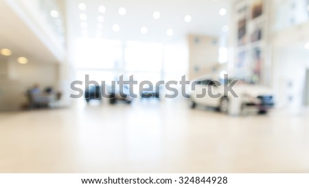 Abstract background of blurred  new cars dealership place Royalty-Free Stock Photo #324844928