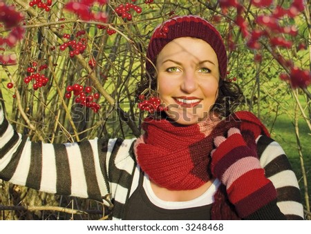 girl beside a red berry-bush in autumn. More pictures of her in my portfolio.