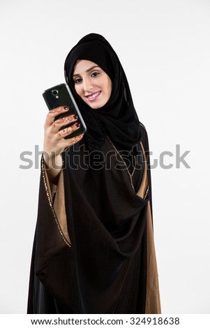 Arab woman taking selfie using mobile camera