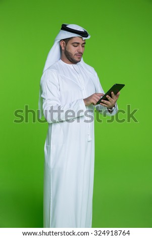 Emirati businessman using digital tablet