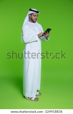 Emirati businessman using digital tablet