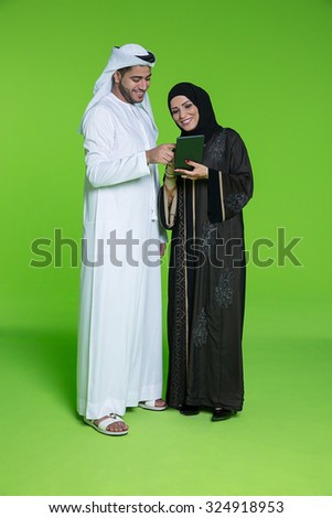 Emirati couple using digital tablet