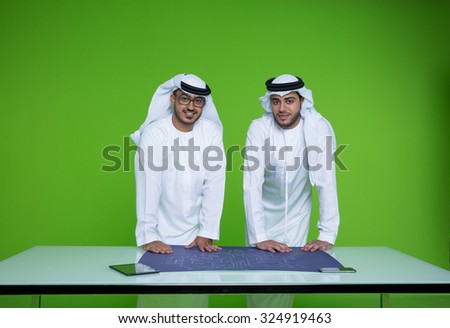 Emirati businessmen with blueprint