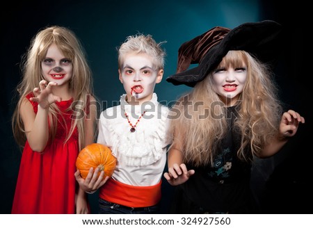 Two girls and boy  wearing  as  vampire and witches. Halloween