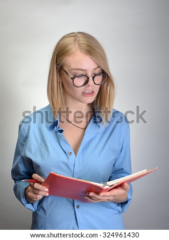 young smiling woman making notes