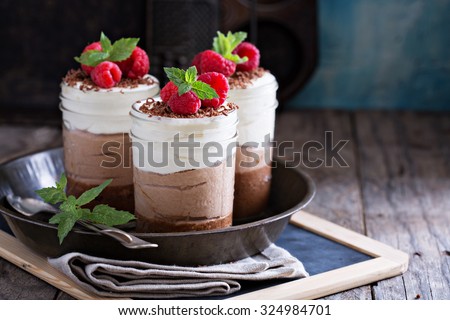 Three chocolate mousse dessert in mason jars Royalty-Free Stock Photo #324984701