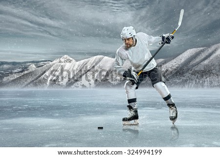Ice hockey player on the ice in mountains