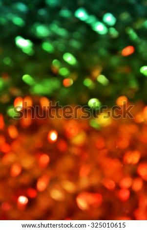 Bright and abstract blurred green and golden background with shimmering glitter