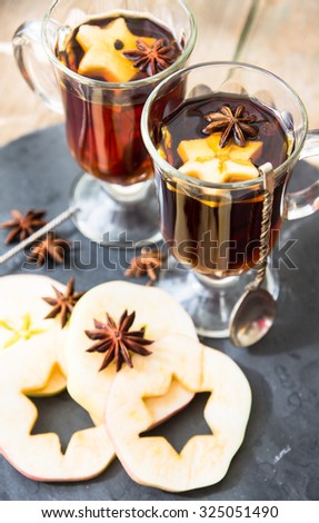 Mulled tea with spices on the old rustic background