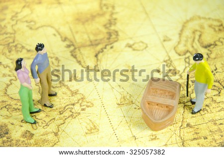 mini model of a man  woman and oldman on a old world map 