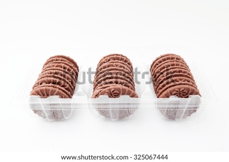 The chocolate sandwich biscuits inside the tray on white background. -stock photo.