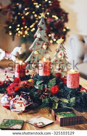 a close up on a living room with Christmas accessories and ornament in the table and a Christmas tree on background