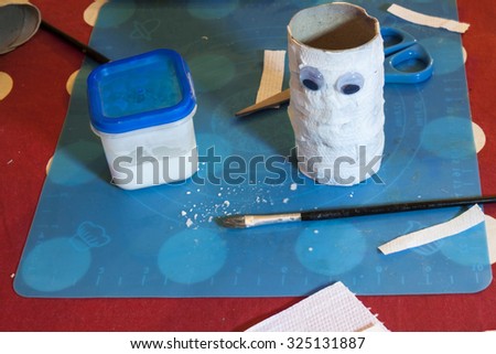 a horizontal view of a scene of a Halloween craft and some of the materials needed