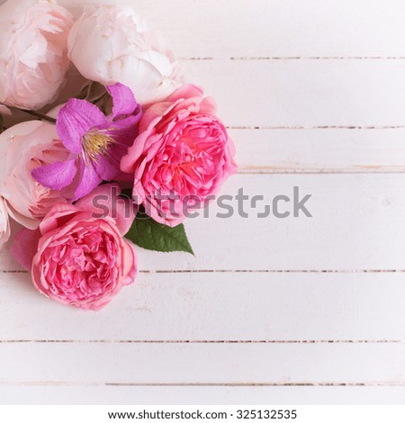 Sweet pastel roses and clematis flower on white  wooden background. Place for text. Selective focus. Square image.