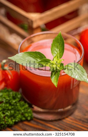 Close up of tomato juice in glass with basil