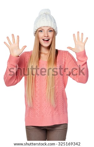 Hand counting - ten fingers. Aim goal achievement concept. Portrait of happy excited woman on white background wearing woolen hat and sweater showing ten fingers