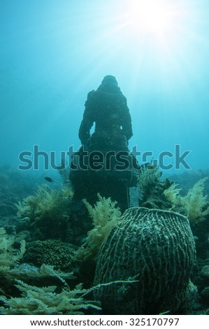 Buddha Statue in underwater Buddha temple of Tulamben, Bali, Indonesia.